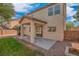 Exterior of the house featuring a covered patio area and mature trees at 11273 Accademia Ct, Las Vegas, NV 89141
