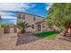 Landscaped backyard featuring a covered patio area and mature trees at 11273 Accademia Ct, Las Vegas, NV 89141