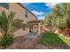 Landscaped backyard featuring a covered patio area and mature trees for shade at 11273 Accademia Ct, Las Vegas, NV 89141