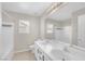 Bright bathroom featuring double sinks, tiled floors, and a shower-tub combination at 11273 Accademia Ct, Las Vegas, NV 89141