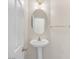 Clean powder room featuring a pedestal sink, an oval mirror and modern lighting at 11273 Accademia Ct, Las Vegas, NV 89141