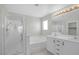 Well-lit bathroom featuring double sinks, a soaking tub, and a separate glass-enclosed shower at 11273 Accademia Ct, Las Vegas, NV 89141