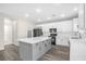 Modern kitchen with white cabinets, gray island, quartz countertops, and stainless steel appliances at 11273 Accademia Ct, Las Vegas, NV 89141
