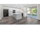 Bright, updated kitchen with center island, black appliances, and sliding glass doors to the yard at 11273 Accademia Ct, Las Vegas, NV 89141