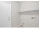 Functional laundry room with tile flooring and a built-in shelf above the hookups at 11273 Accademia Ct, Las Vegas, NV 89141