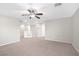 Open loft area with neutral carpet and natural light from windows at 11273 Accademia Ct, Las Vegas, NV 89141