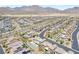 Overhead view of a new neighborhood with swimming pools, mountains, and desert landscape in the background at 12273 Catanzaro Ave, Las Vegas, NV 89138