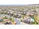 A sprawling neighborhood is showcased, featuring uniform landscaping, pools, and warm terra-cotta roofs at 12273 Catanzaro Ave, Las Vegas, NV 89138