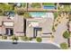 Aerial view of backyard with large pool and jacuzzi, lush landscaping, and stone fire pit at 12273 Catanzaro Ave, Las Vegas, NV 89138
