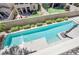 Aerial view of a backyard featuring a pool, patio, manicured lawn, and surrounding landscape at 12273 Catanzaro Ave, Las Vegas, NV 89138
