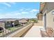 Balcony with wrought iron railing overlooking neighborhood and mountains in the distance at 12273 Catanzaro Ave, Las Vegas, NV 89138