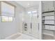 Bright bathroom featuring glass shower and built in shelves for storage at 12273 Catanzaro Ave, Las Vegas, NV 89138