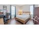 Cozy bedroom with hardwood floors, a wooden bed frame, and a comfortable desk area at 12273 Catanzaro Ave, Las Vegas, NV 89138