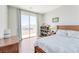 Bedroom with hardwood floors and sliding glass door with balcony access at 12273 Catanzaro Ave, Las Vegas, NV 89138