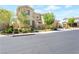 Charming two-story home with stone accents, lush landscaping, and a welcoming entryway, near a quiet street at 12273 Catanzaro Ave, Las Vegas, NV 89138