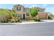 Charming stucco home with stone accents, a well-manicured landscape and a two-car garage at 12273 Catanzaro Ave, Las Vegas, NV 89138