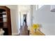 Hallway with hardwood floors and decorative vase of sunflowers on light wood furniture at 12273 Catanzaro Ave, Las Vegas, NV 89138