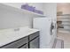Laundry room area featuring sink and newer appliances with shelves for storage at 12273 Catanzaro Ave, Las Vegas, NV 89138