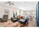 Bright and airy living room featuring hardwood floors, a sectional sofa, and an open floor plan at 12273 Catanzaro Ave, Las Vegas, NV 89138