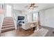 Bright living room featuring a staircase, television, wood floors, and ample natural light at 12273 Catanzaro Ave, Las Vegas, NV 89138