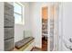Organized mud room with storage bench, window and adjacent pantry storage at 12273 Catanzaro Ave, Las Vegas, NV 89138