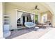 Inviting covered patio with outdoor seating, ceiling fan, and views of the backyard at 12273 Catanzaro Ave, Las Vegas, NV 89138