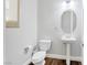 Charming powder room with pedestal sink, decorative lighting, and wood flooring at 12273 Catanzaro Ave, Las Vegas, NV 89138
