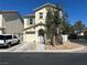 Charming two-story home with a tile roof, attached garage, and desert landscaping at 1310 Golden Apple St, Las Vegas, NV 89142