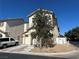 Inviting two-story home with a tile roof, a tree in front, and street view at 1310 Golden Apple St, Las Vegas, NV 89142