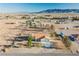 Expansive aerial view of a desert home with an orange roof, a long driveway, and mountain views at 1601 Iguana St, Pahrump, NV 89048