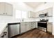 Modern kitchen featuring stainless steel appliances, wood flooring, and bright countertops at 1601 Iguana St, Pahrump, NV 89048