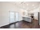 Open-concept living area with French doors, hardwood floors, and modern gray kitchen at 1601 Iguana St, Pahrump, NV 89048