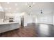 Open-concept kitchen and living room with hardwood floors and recessed lighting at 1601 Iguana St, Pahrump, NV 89048