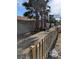 Backyard with palm trees and a partial fence, showcasing the lot's potential at 1655 N Gateway Rd, Las Vegas, NV 89115