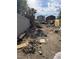 Overgrown backyard featuring debris and sparse vegetation at 1655 N Gateway Rd, Las Vegas, NV 89115