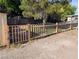 View of a backyard with a wooden fence and an open gate at 1655 N Gateway Rd, Las Vegas, NV 89115