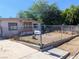 Exterior view of home with chain link fence and arid landscaping at 1655 N Gateway Rd, Las Vegas, NV 89115