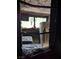 Interior view through a fire-damaged kitchen window showing extensive fire damage at 1655 N Gateway Rd, Las Vegas, NV 89115