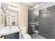 Modern bathroom with a glass-enclosed shower, black subway tile and a large vanity at 2040 Bavington Dr # D, Las Vegas, NV 89108