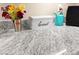 Close-up of kitchen countertop featuring granite, breadbox, flowers, and stylish design at 2040 Bavington Dr # D, Las Vegas, NV 89108