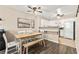 Bright dining area with wood flooring, a wooden table and white chairs, and a view into the adjacent kitchen at 2040 Bavington Dr # D, Las Vegas, NV 89108