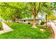Charming exterior of a home with lush green lawn and mature trees at 2040 Bavington Dr # D, Las Vegas, NV 89108