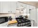 Well-lit kitchen featuring stainless steel appliances and white cabinetry at 2040 Bavington Dr # D, Las Vegas, NV 89108