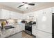 Well-lit kitchen with stainless steel appliances, white cabinetry, and modern countertops for a clean aesthetic at 2040 Bavington Dr # D, Las Vegas, NV 89108