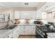 Modern kitchen with white cabinets, stainless steel appliances, and granite countertops at 2040 Bavington Dr # D, Las Vegas, NV 89108