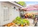 Inviting patio featuring a shaded seating area, potted plants, and secure entry, ideal for enjoying outdoor living at 2040 Bavington Dr # D, Las Vegas, NV 89108