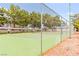 Community tennis court surrounded by mature trees in a fenced area at 2040 Bavington Dr # D, Las Vegas, NV 89108