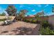 Charming backyard featuring a brick patio, gravel landscaping, and a cozy outdoor seating area at 2332 Mundare Dr, Henderson, NV 89002