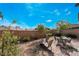 The backyard is equipped with a brick patio, mature landscaping, a cozy seating area, and beautiful desert foliage at 2332 Mundare Dr, Henderson, NV 89002