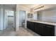 A spacious bathroom with dual sinks leads to the toilet and walk-in closet at 2332 Mundare Dr, Henderson, NV 89002